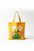 Hand-painted canvas tote bag with a golden flower design