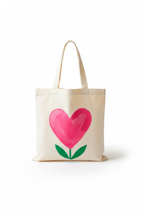 Hand-painted canvas tote bag with a pink heart design